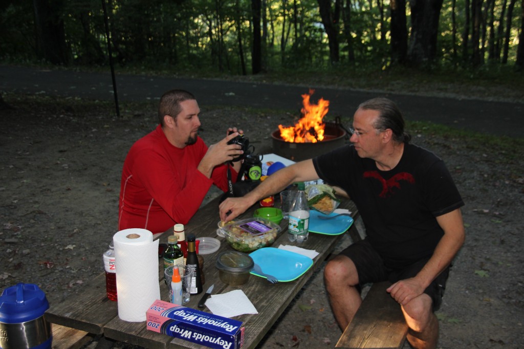 Men-folk munching on appetizers while the hobos do their thing in the fire.