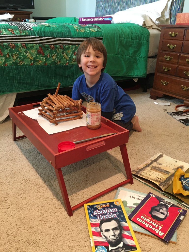 Creating a pretzel/peanut butter log cabin during our Presidents Unit Study